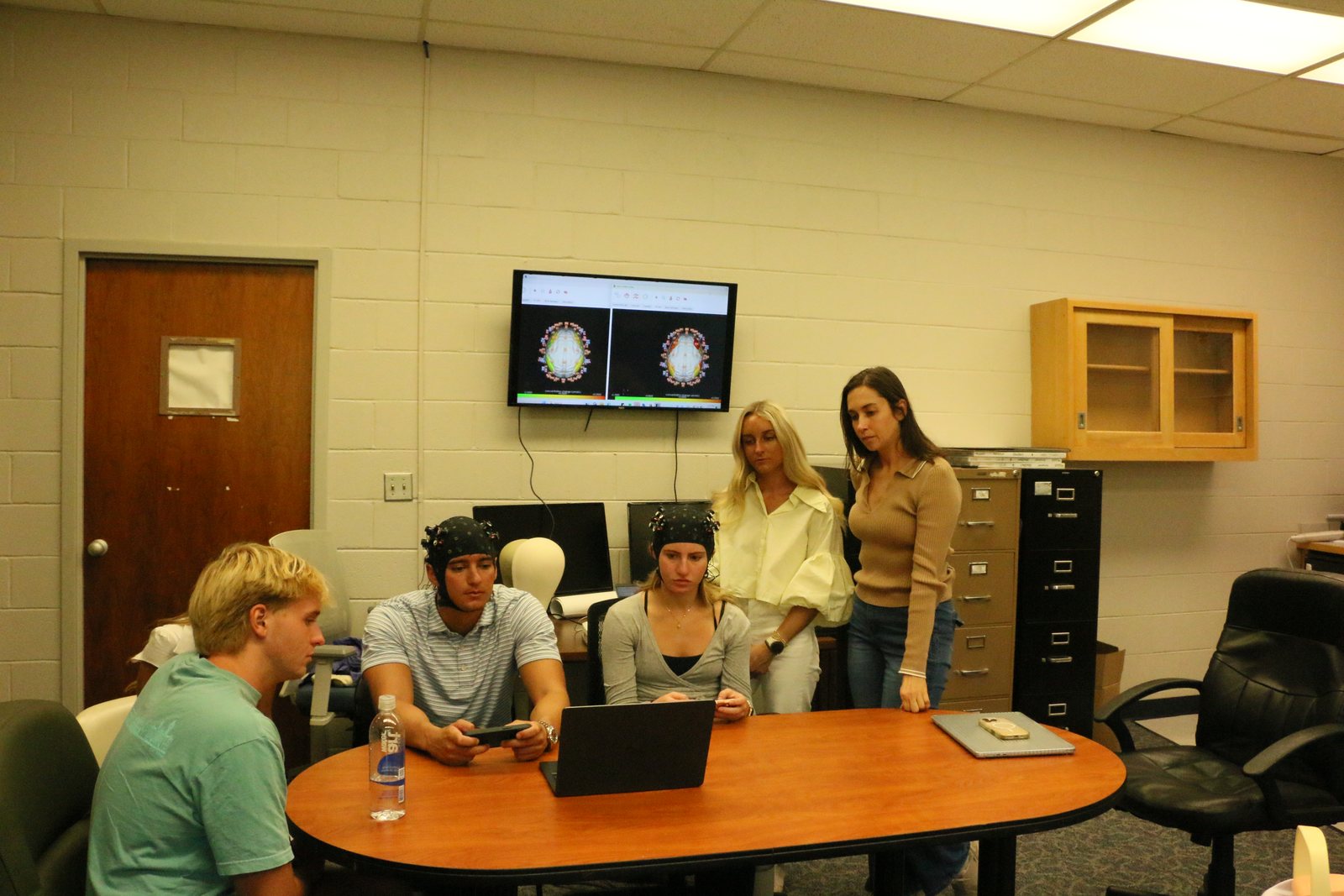 Students observing live fNIRS recordings during a classroom demonstration