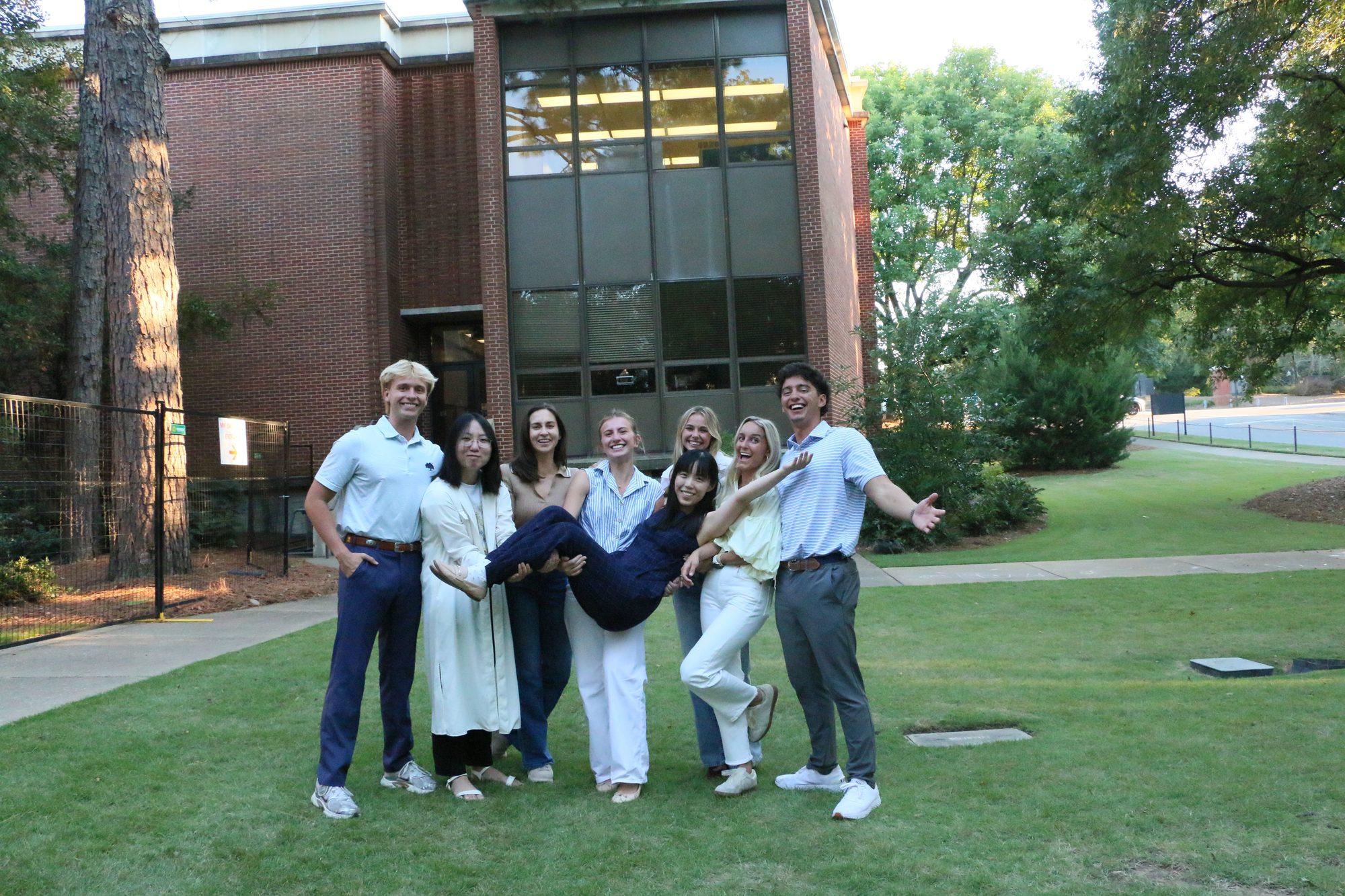 The CONNECT Lab team being silly — lifting a lab member off the ground